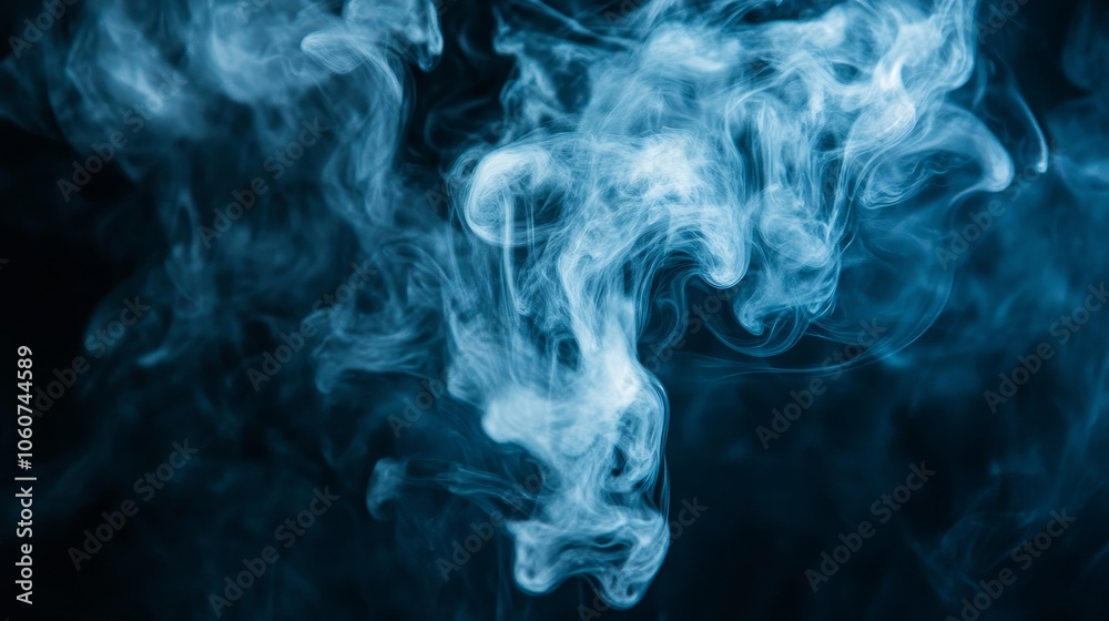 Fototapeta premium A swirling pattern of blue smoke against a dark background, creating an ethereal atmosphere.