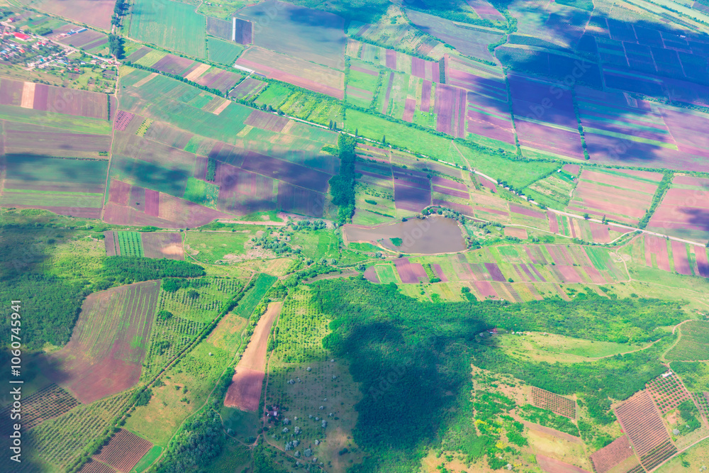 Plane soars above a lush green fields, showcasing the vastness of the landscape below. Rustic fields and flatland view from above Plane soars above a lush green fields, showcasing the vastness of the landscape below. Rustic fields and flatland view from above