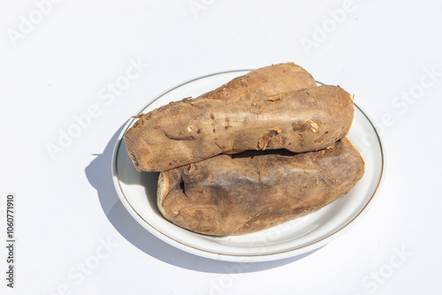 Sweet potato set on ceramic plate on white background photo