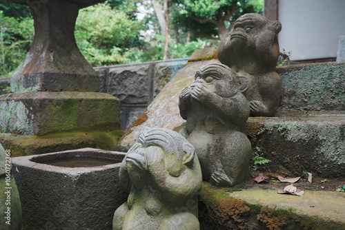 神社の階段にある三猿の石像 photo