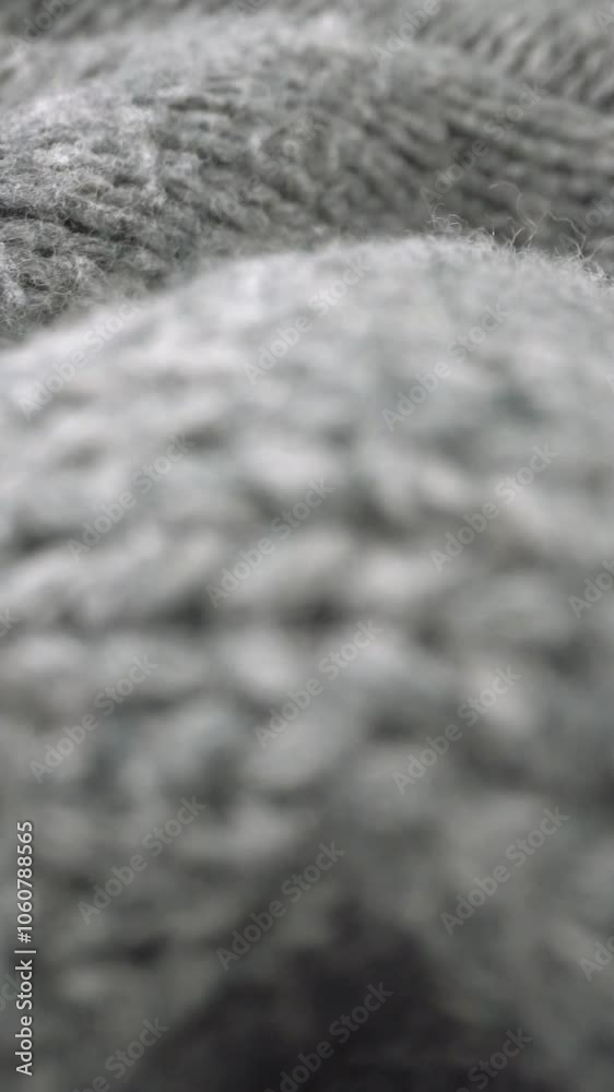 Extreme detail view of sheep wool cloth texture in macro dolly shot. Flowing animal fiber material for handcraft knitting. Textile abstract background. Winter fashion clothing industry concept.