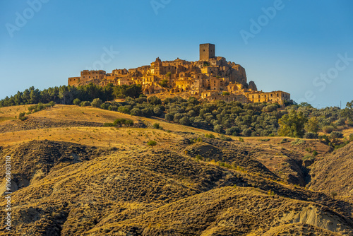 A picturesque view of the abandoned, old mountain town of Craco, built of sandstone rock. Craco is a ghost town abandoned due to an earthquake in the late 20th century. Province of Matera, Basilicata,