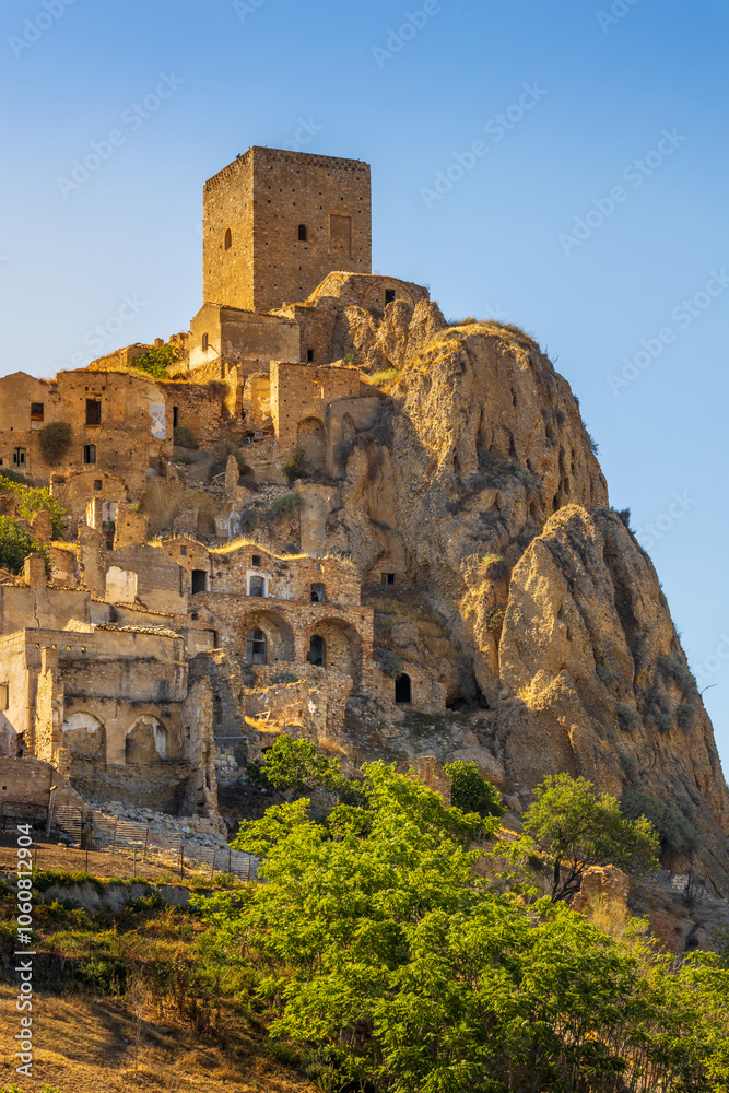 A picturesque view of the abandoned, old mountain town of Craco, built of sandstone rock. Craco is a ghost town abandoned due to an earthquake in the late 20th century. Province of Matera, Basilicata,