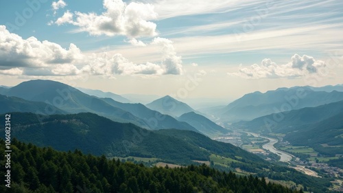 Scenic view of a rolling green valley with winding river and distant mountains under a clear blue sky, explore, relax photo