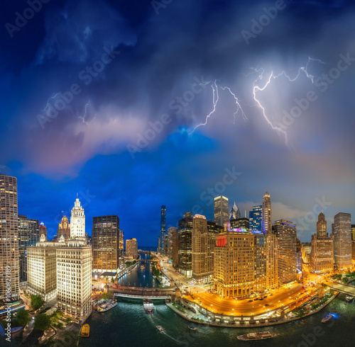 Panoramic aerial view of Chicago skyline along Chicago River on a stormy night