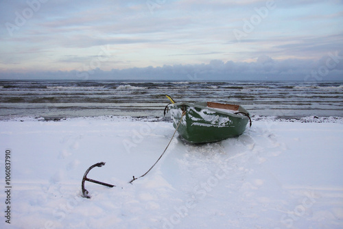 Winter landscape from the seashore,.  Fisherman boat on the seashore,  ice texture in Winter. 
