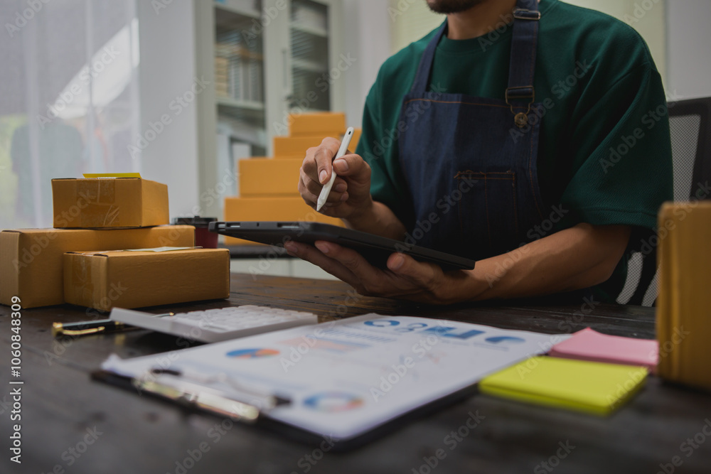 An Asian man carefully prepares a package for a customer's online order, methodically placing items in a box, sealing it securely, and attaching a shipping label for prompt delivery. An Asian man carefully prepares a package for a customer's online order, methodically placing items in a box, sealing it securely, and attaching a shipping label for prompt delivery.