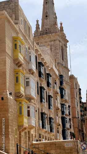 Typical narrow streets with colorful balconies in Malta. Traditional colorful balconies in old town of Valletta, Malta. Architecture background. Facade of the building in the old town, Malta island