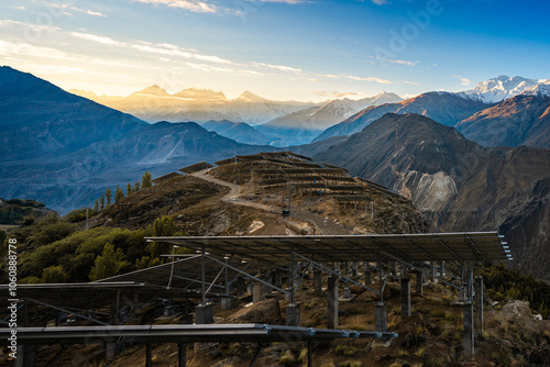 A breathtaking sunrise illuminates this innovative solar panel installation at Duikar Hill Viewpoint in Hunza Valley, Gilgit Baltistan, Pakistan.