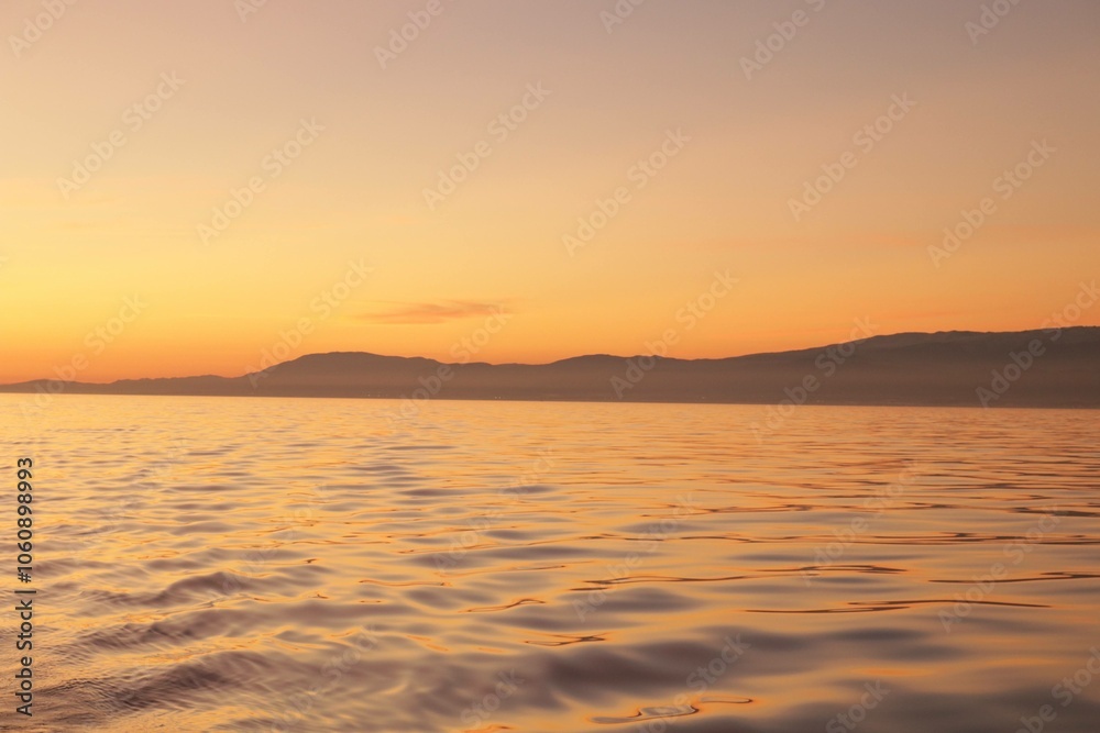 Fototapeta premium Sunset with Silhoutted Mountain Range in the Atlantic Ocean