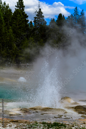 Geysers with hot water spew steam in Yellowstone National Park