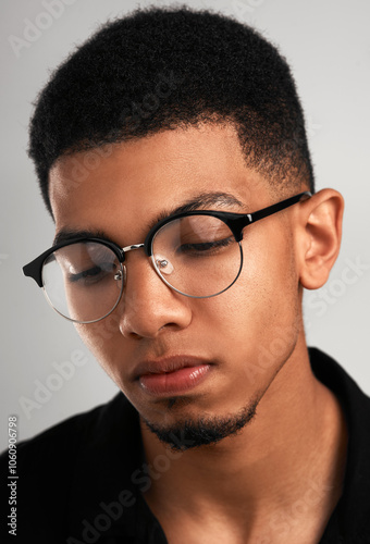 Fashion, glasses and face of man in studio for optometry, vision and prescription lens. Serious, eyewear style and closeup of isolated person with accessories, pride and frames on white background