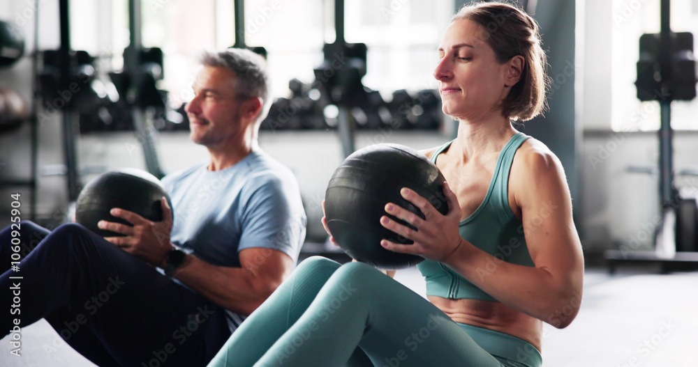Couple Doing Abdominal Sit Up Workout In Gym Couple Doing Abdominal Sit Up Workout In Gym