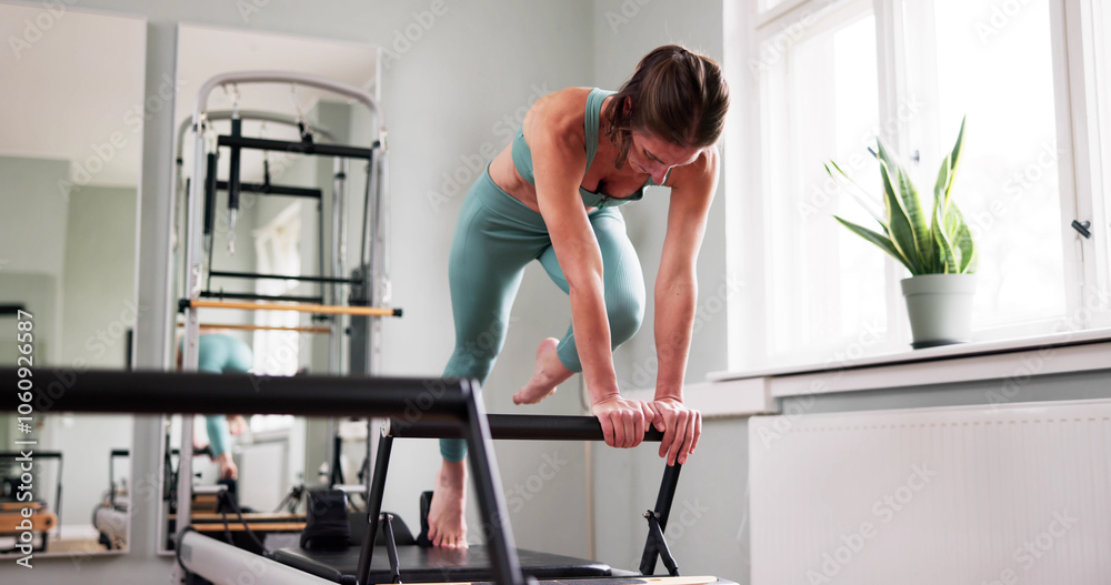 Fototapeta premium Woman Doing Pilates Workout In Gym