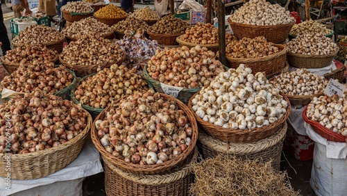 Farmers market stall with fresh onions and garlic bulbs in baskets creating a rustic feel photo