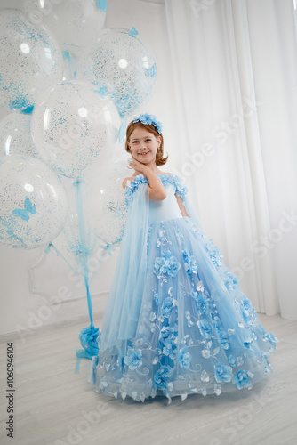 little girl in blue dress with giant helium balloons