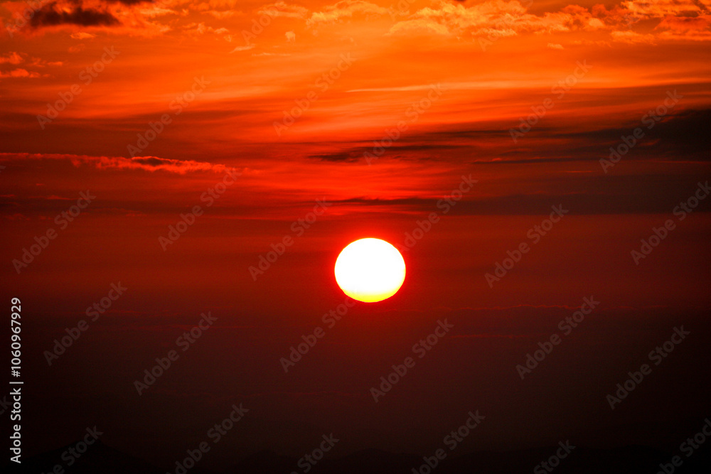 deep red sunset over the mountains with grey mist deep red sunset over the mountains with grey mist