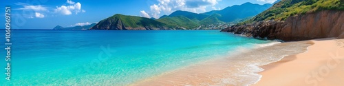 A beautiful beach with a blue ocean and a rocky shore. The beach is empty and the water is calm