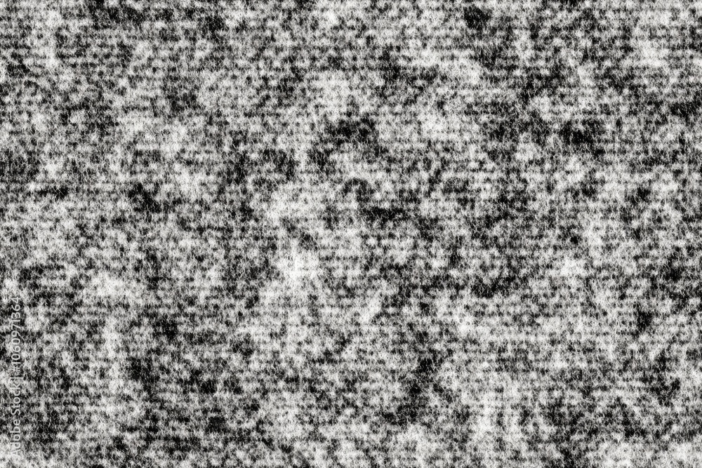Fototapeta premium A black and white, close-up image of a rough, textured surface. The texture is primarily composed of many small, white flecks on a black background