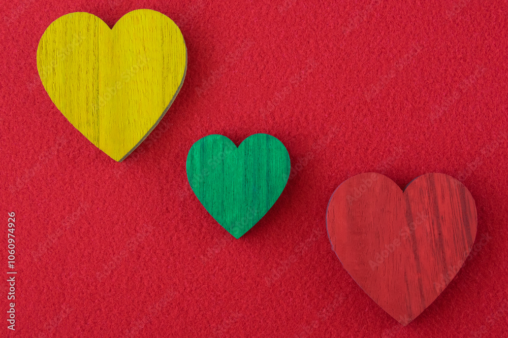Obraz premium Traffic light green, yellow, red hearts on the red background.