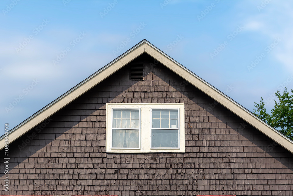 Rustic brown shingle house with white-trimmed windows in Brighton, Massachusetts, USA Rustic brown shingle house with white-trimmed windows in Brighton, Massachusetts, USA