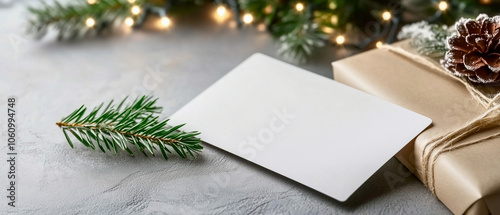 christmas composition with blank gift card / envelope isolated over xmas decor; copy space