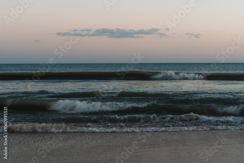 Smooth, blurred waves reflecting dusk light in serene tones.