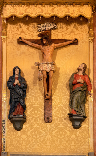 Εκτύπωση καμβά PAVIA, ITALY - SEPTEMBER 8, 2024: The carved polychrome Crucifixion with the Mary and Joh in the church Chiesa di Santa Maria del Carmine by Giovanni Battista Trucazzano (1638 - 1645)