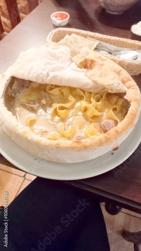 pasta with cheese and meat cooked in a frying pan and covered with a pancake