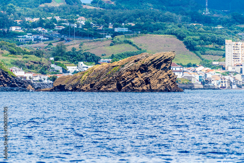 A view from a boat towards the Dog Face islet on the island of San Miguel in the Azores in summertime photo