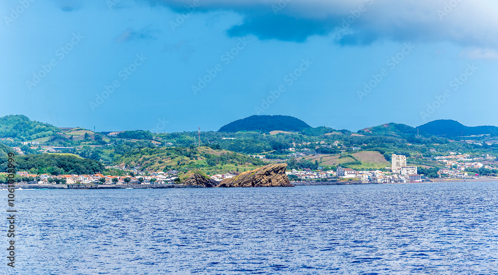 Fototapeta premium A view from a boat along the coast around the Dog Face Islet on the island of San Miguel in the Azores in summertime
