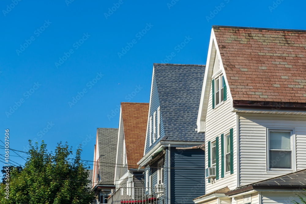 Row of traditional gable-roof houses on sunny summer day in Brighton, Massachusetts, USA Row of traditional gable-roof houses on sunny summer day in Brighton, Massachusetts, USA