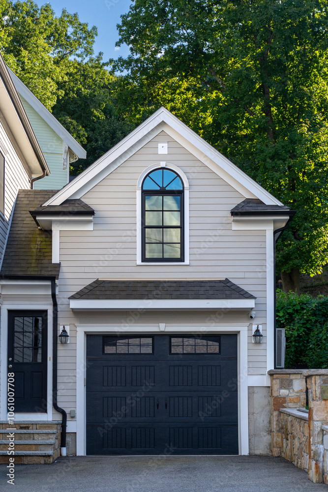Elegant garage facade with arched window and white accents in Brighton, Massachusetts, USA Elegant garage facade with arched window and white accents in Brighton, Massachusetts, USA
