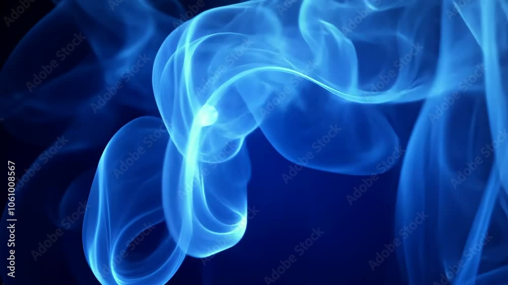 Blue smoke swirls against a dark blue background Blue smoke swirls against a dark blue background