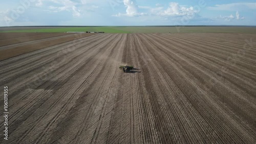 Yellow Tractor Planting Corn in the Fields