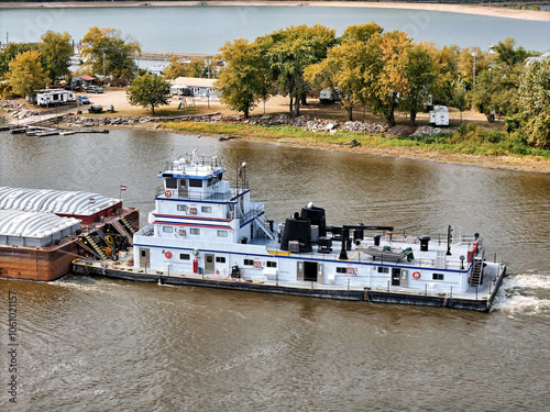 Close up of a Tug boat pushing a large set of barges up the Mississippi River photo