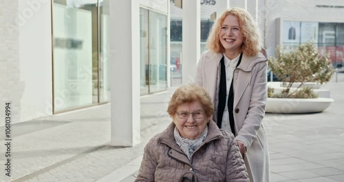 A caregiver with a bright smile is helping an elderly woman in a wheelchair enjoy the beautiful outdoors