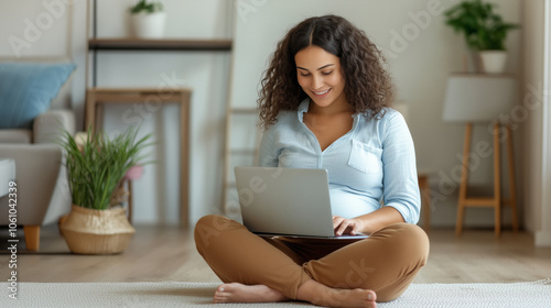 A pregnant woman with curly hair sits cross-legged on her living room floor,smiling as she uses her laptop in a cozy and well-decorated space,reflecting her joy and peaceful anticipation of motherhood