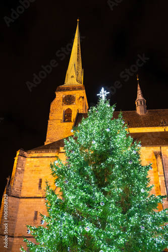 Obraz na płótnie A festive scene with Christmas decorations in the foreground and the Cathedral of St. Bartholomew in Plzen, Czech Republic, in the background. A charming mix of tradition and holiday spirit w salonie