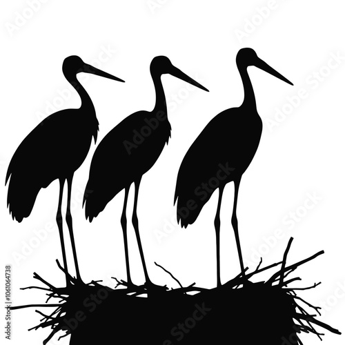 a black silhouette of three storks standing on top of a nest.