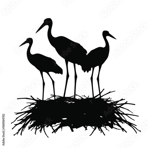 a black silhouette of three storks standing on top of a nest.
