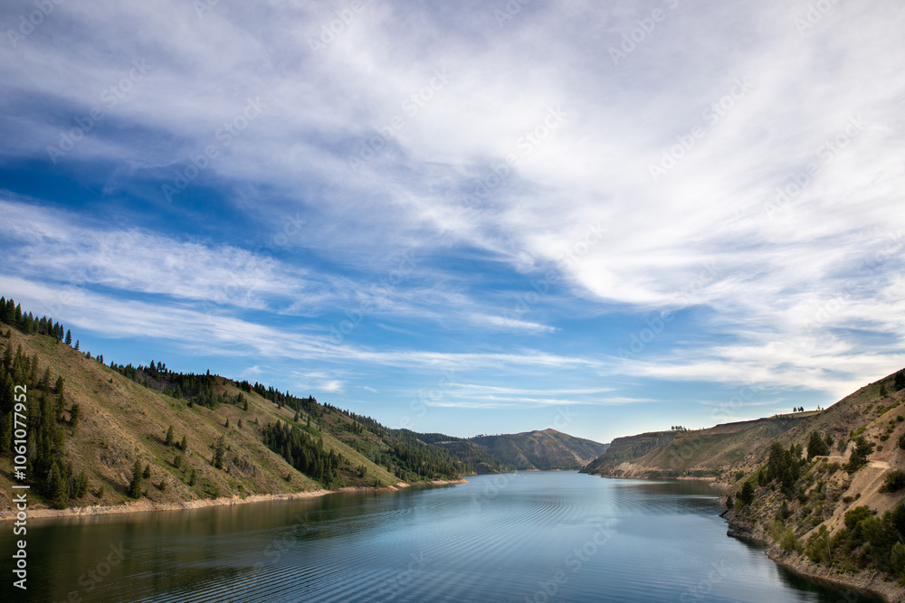 Scenic Landscape of River and Hills Under Blue Sky