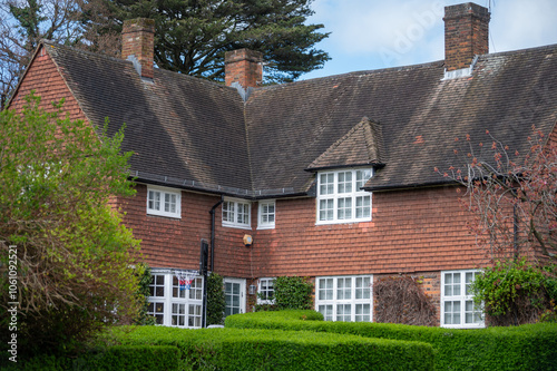 Walking on streets of North London, red brick houses and flowering gardens in spring, city life, wealthy neighbourhoods in London, UK photo