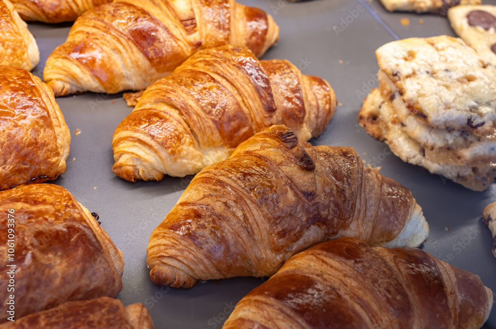 Fresh baked buttered croissants and sweet buns, pastries in village bakery in France Fresh baked buttered croissants and sweet buns, pastries in village bakery in France