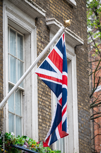 National flag of the United Kingdom is the Union Jack, also known as the Union Flag on houses in central London, UK