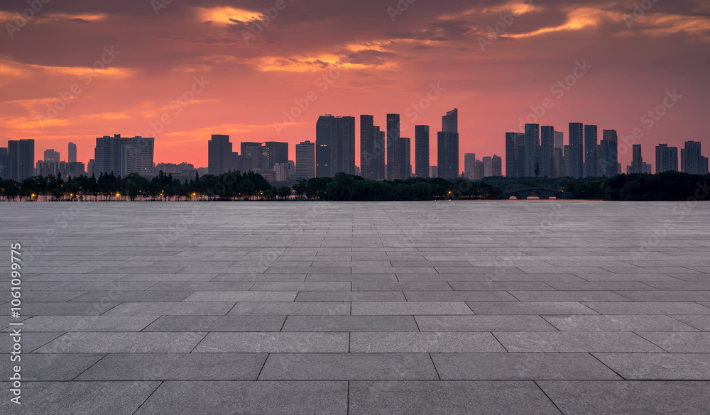 Dramatic Sunset Over Modern City Skyline with Expansive Foreground Dramatic Sunset Over Modern City Skyline with Expansive Foreground
