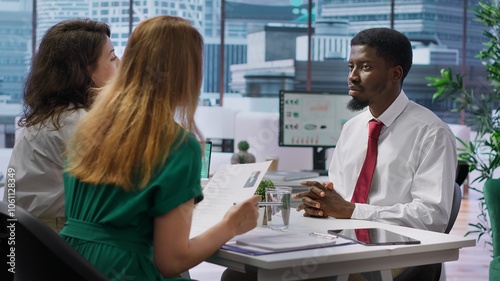 Job seeker presents his CV resume to HR recruiters during a corporate interview, discussing his past achievements and career aspirations. Employees looking for personnel with experience. Camera A.