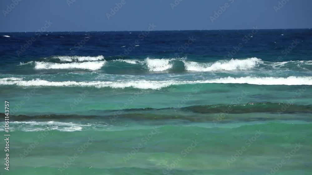 The waves of the turquoise Indian Ocean roll towards the coast. The waves of the turquoise Indian Ocean roll towards the coast.