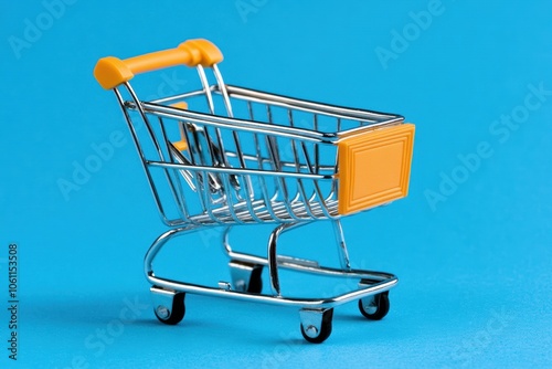 A miniature shopping cart on a blue background - Transportation