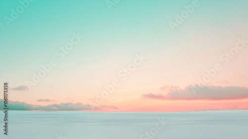 Soft pastel colors paint the sky over a vast snow-covered landscape, creating a serene and dreamy winter scene during a beautiful sunset